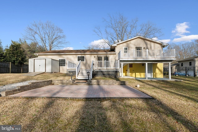 view of front facade featuring a front yard, a storage shed, a patio, and a wooden deck