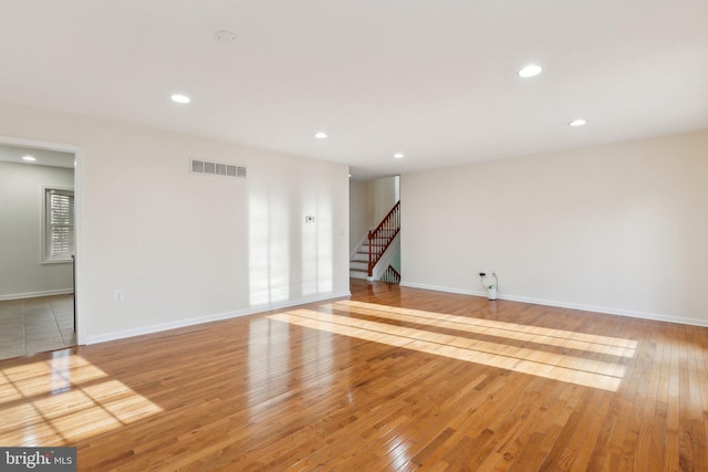 spare room with light hardwood / wood-style floors