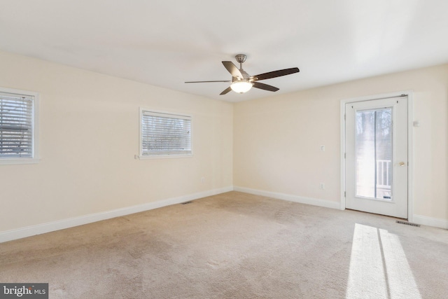 carpeted empty room featuring ceiling fan