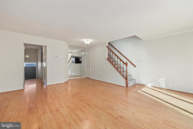 unfurnished living room with ornamental molding and wood-type flooring