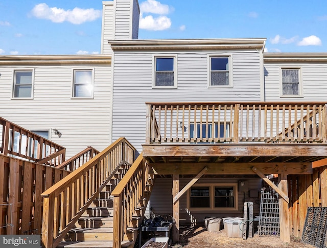 back of house featuring a wooden deck