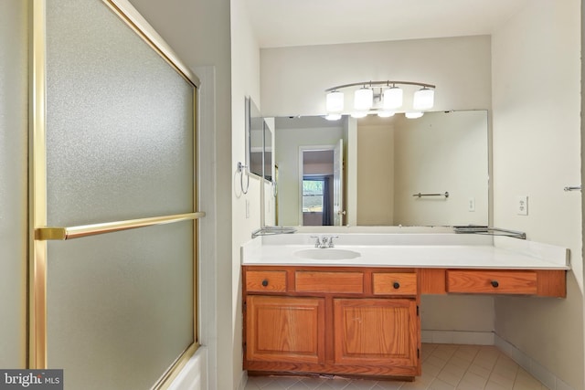 bathroom featuring vanity, bath / shower combo with glass door, and tile patterned flooring