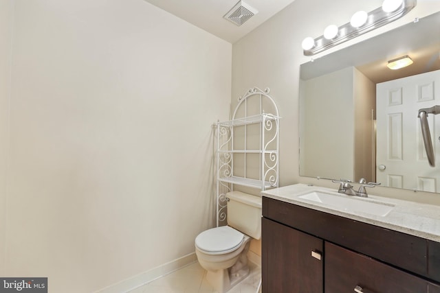 bathroom featuring vanity, toilet, and tile patterned flooring