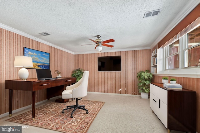 office featuring crown molding, light carpet, ceiling fan, and a textured ceiling