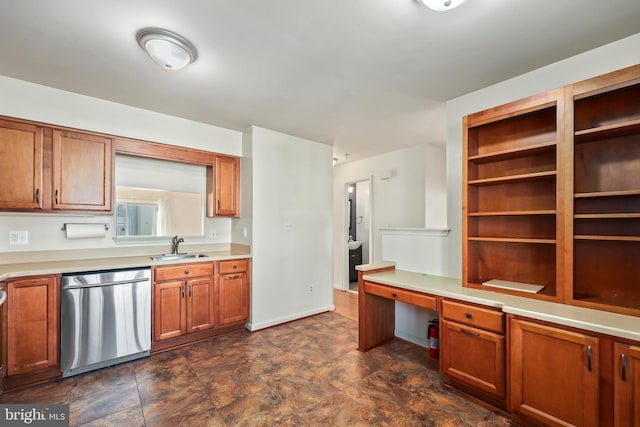 kitchen with built in desk, sink, and stainless steel dishwasher