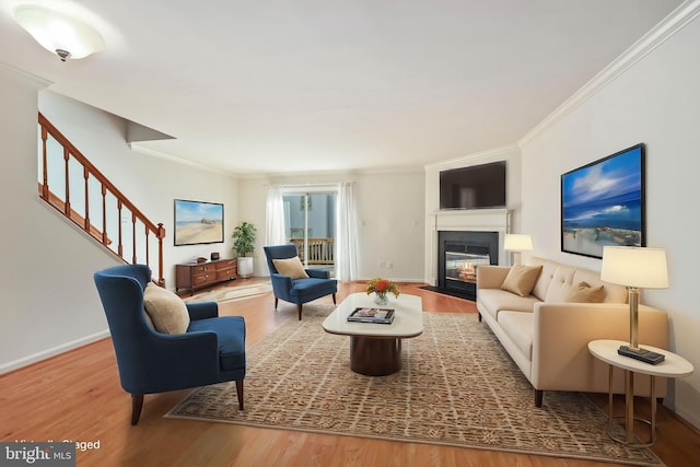 living room with hardwood / wood-style flooring and crown molding