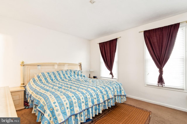 carpeted bedroom featuring multiple windows