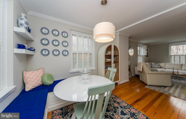 dining room featuring crown molding and hardwood / wood-style flooring