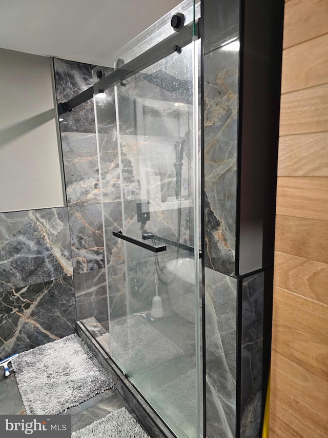 bathroom with a shower with shower door