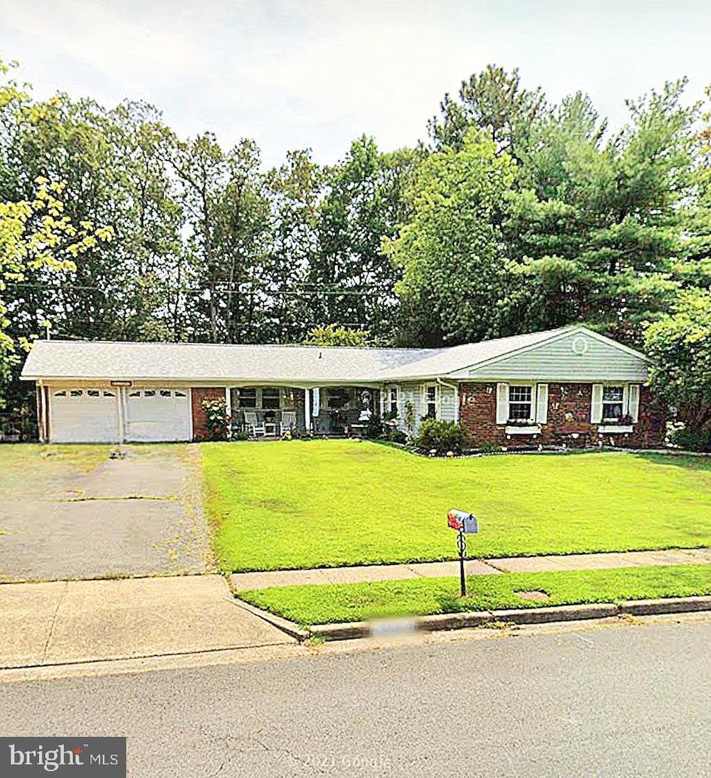 single story home with a front yard and a garage