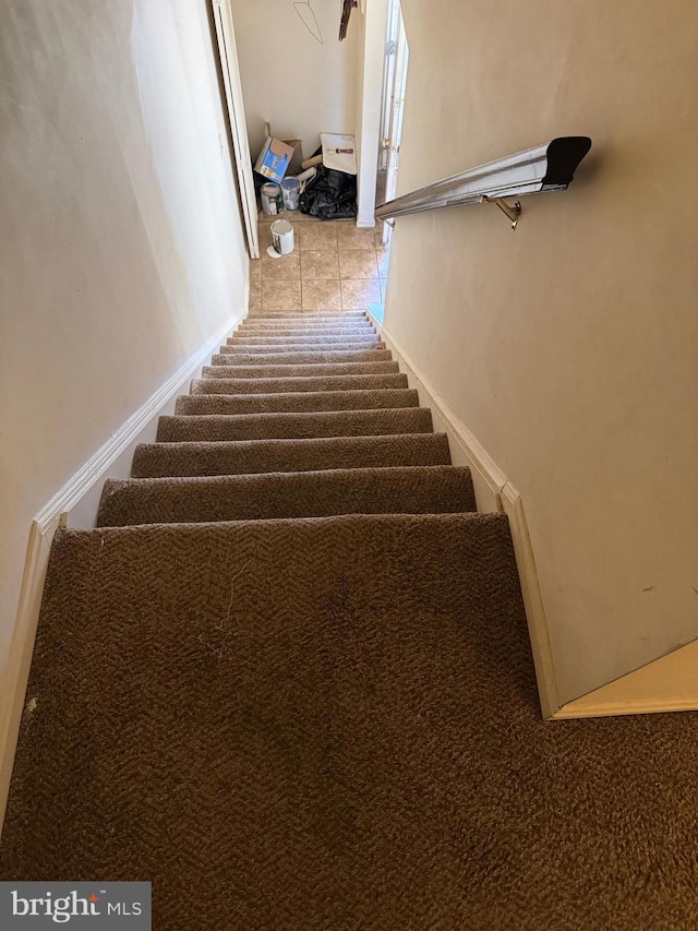 stairs featuring tile patterned flooring