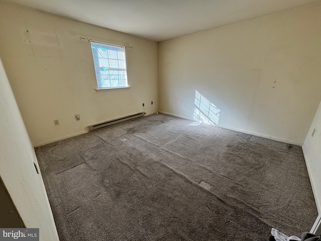 empty room with carpet flooring and a baseboard radiator