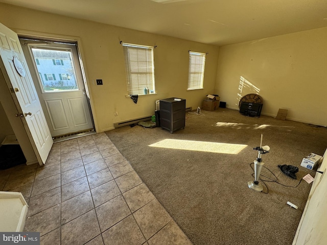 interior space with a baseboard radiator and a healthy amount of sunlight