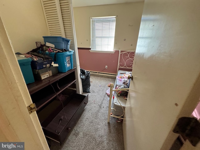 interior space with carpet flooring and a baseboard heating unit