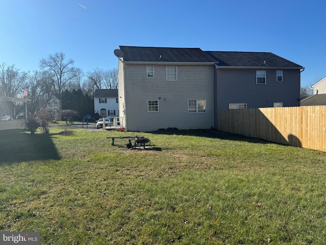 rear view of property featuring a yard