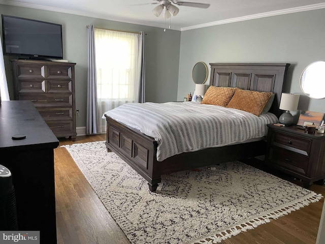 bedroom featuring ornamental molding, ceiling fan, and dark wood-type flooring