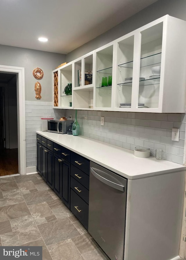 bar featuring white cabinetry and appliances with stainless steel finishes