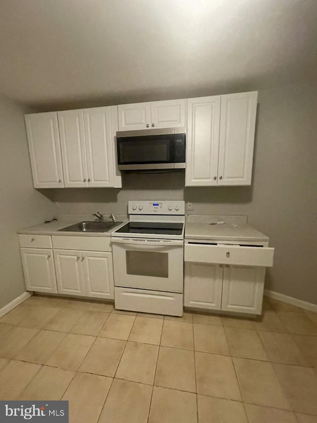 kitchen with white range with electric stovetop, white cabinetry, and sink