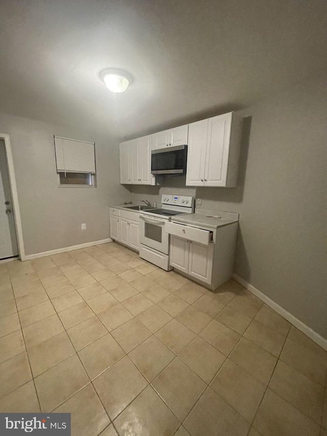 kitchen with light tile patterned floors, white cabinetry, white range with electric stovetop, and sink