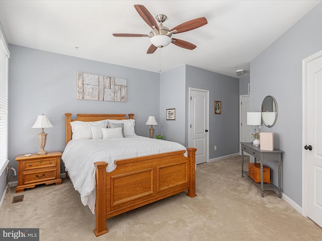 carpeted bedroom with multiple windows and ceiling fan