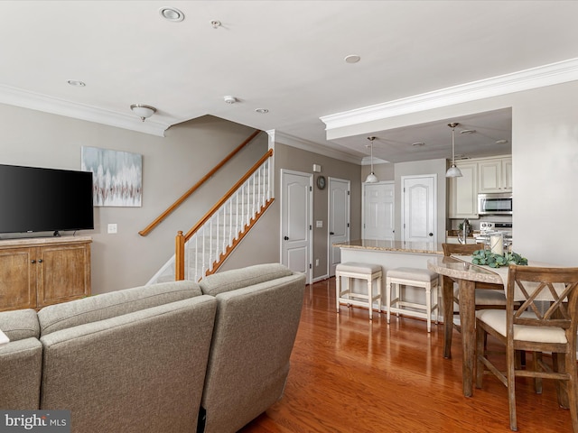 living room featuring dark hardwood / wood-style flooring and ornamental molding