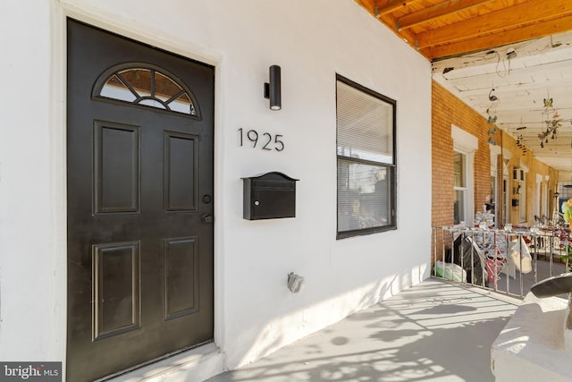 view of exterior entry with covered porch