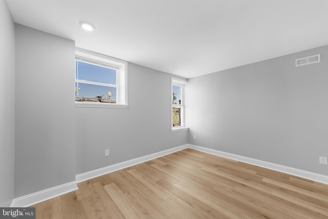 empty room with a healthy amount of sunlight and light wood-type flooring