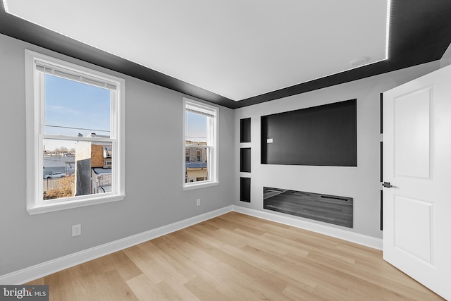 unfurnished living room with light wood-type flooring