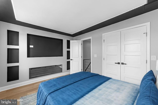 bedroom featuring wood-type flooring and a closet