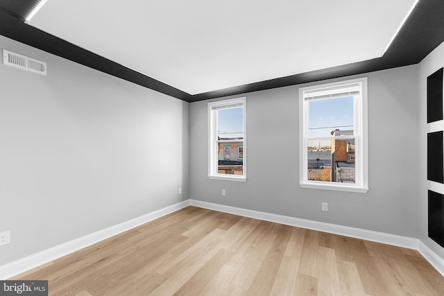 empty room with light hardwood / wood-style flooring