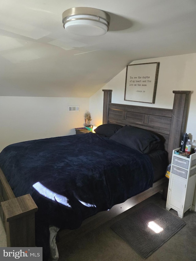 carpeted bedroom with lofted ceiling