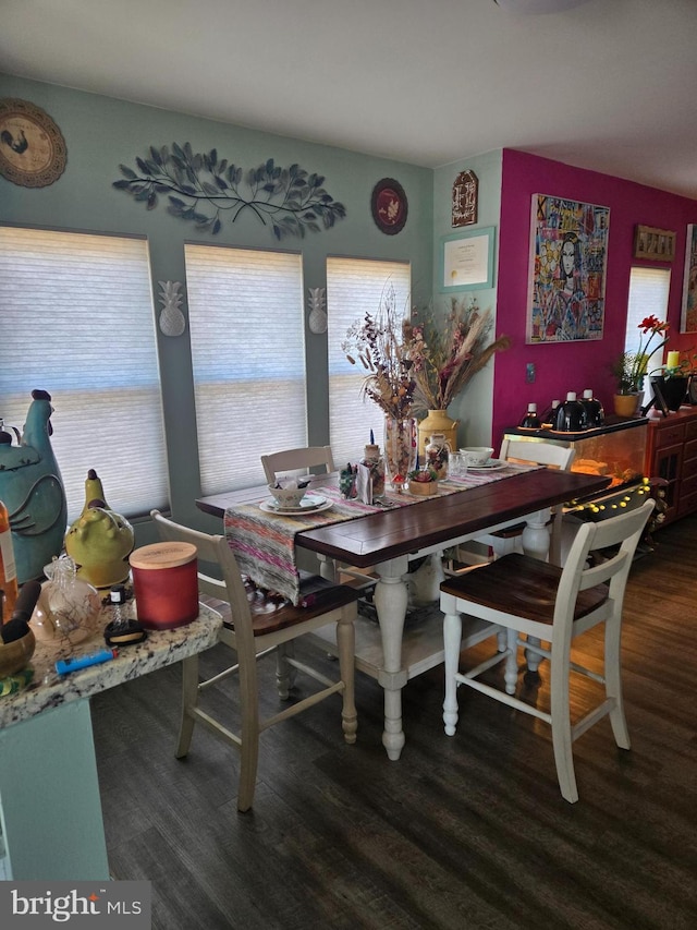 dining space with dark hardwood / wood-style flooring