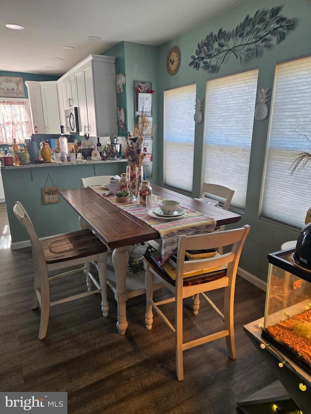 dining space with dark hardwood / wood-style floors