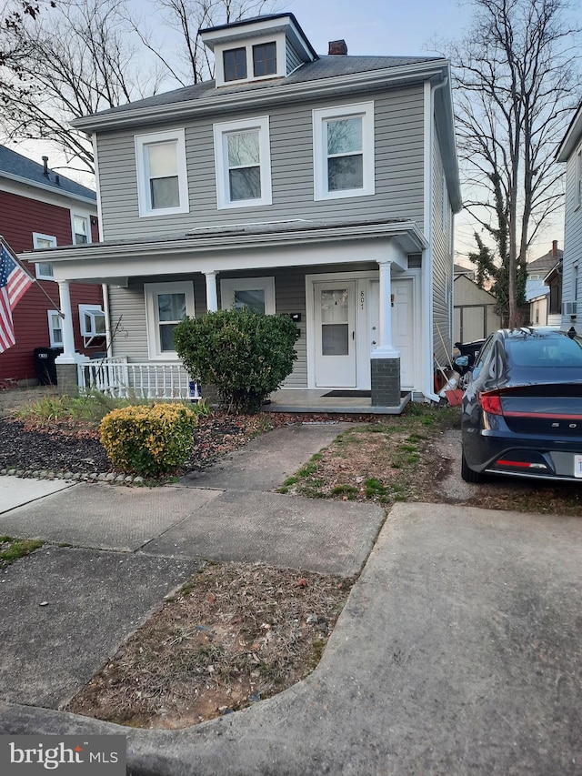 view of property with cooling unit and covered porch