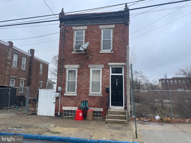 1137 Sycamore St, Camden, NJ 08103 - rear view of house featuring brick siding, entry steps, and fence