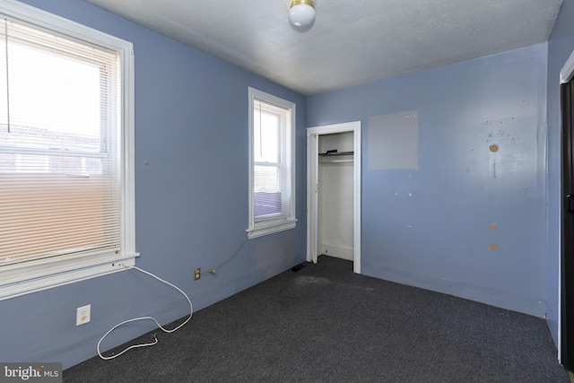 1137 Sycamore St, Camden, NJ 08103 - unfurnished bedroom with dark colored carpet and a closet
