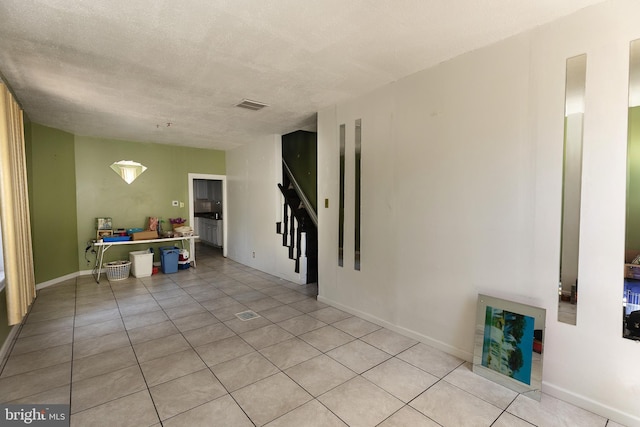 1137 Sycamore St, Camden, NJ 08103 - unfurnished room with light tile patterned floors, stairs, and baseboards