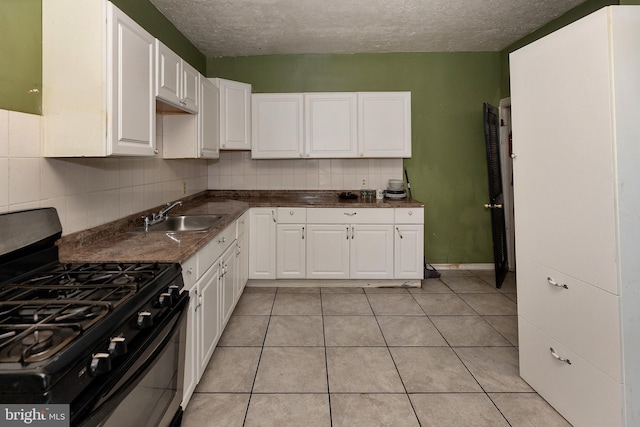 1137 Sycamore St, Camden, NJ 08103 - kitchen with range with gas cooktop, a sink, white cabinets, backsplash, and a textured ceiling
