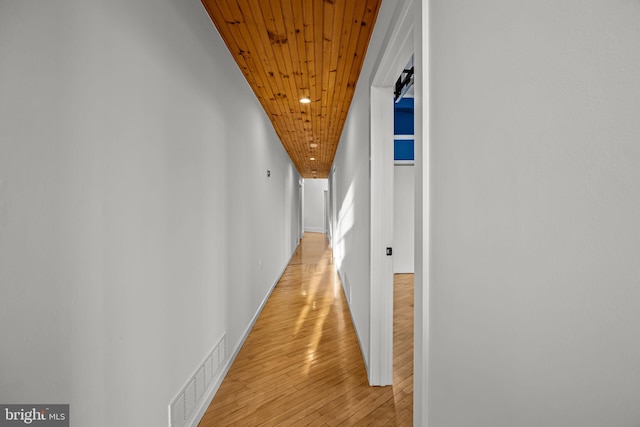 corridor featuring wood ceiling and light hardwood / wood-style flooring