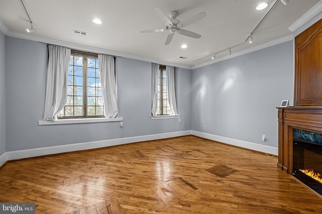 unfurnished living room featuring ceiling fan, parquet floors, crown molding, track lighting, and a fireplace