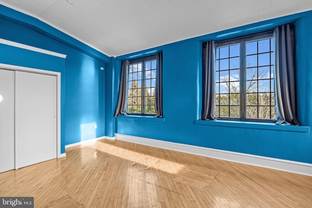 foyer featuring hardwood / wood-style flooring and vaulted ceiling