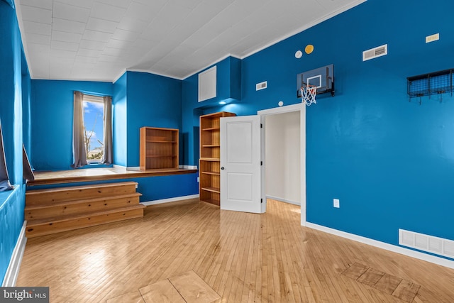 unfurnished bedroom featuring light wood-type flooring and lofted ceiling