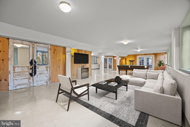 living room featuring pool table, wooden walls, and french doors