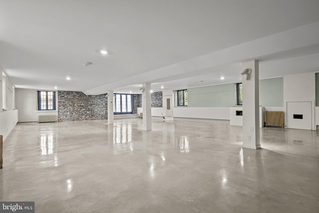 unfurnished living room with radiator heating unit