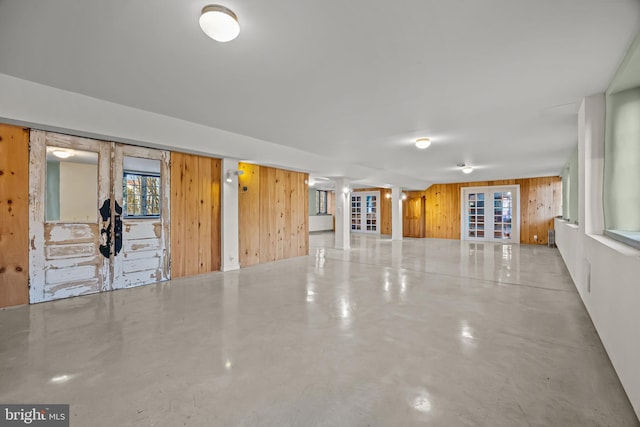 empty room with concrete floors and wooden walls