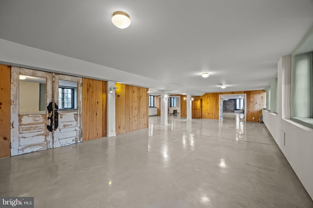 interior space with wooden walls and concrete flooring