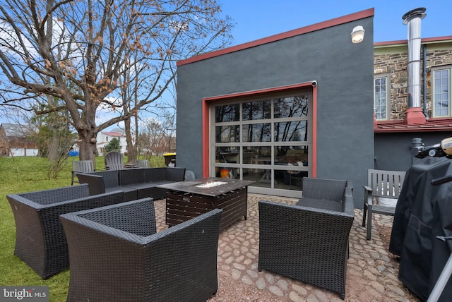 view of patio / terrace featuring an outdoor living space with a fire pit