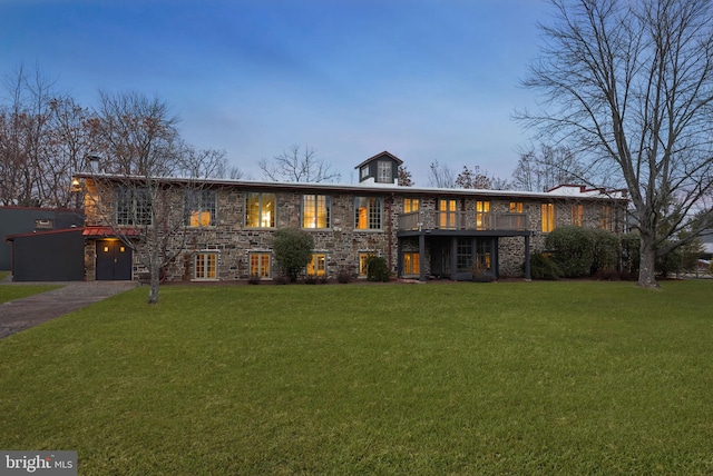 view of front of house featuring a wooden deck and a lawn