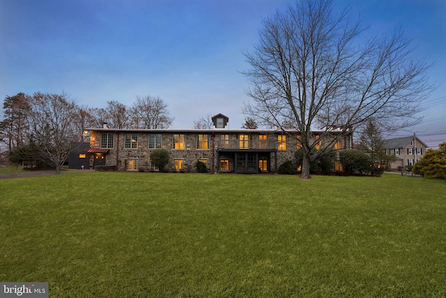 view of front of property with a yard