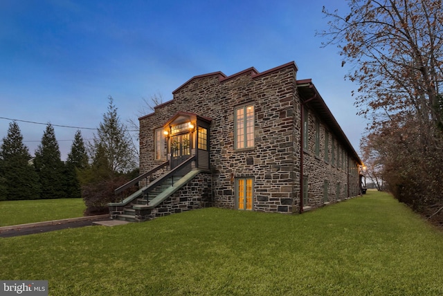 property exterior at dusk with a yard